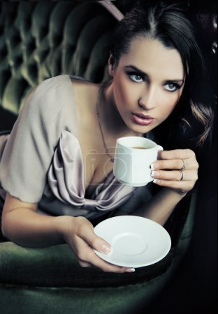 Calm lady drinking coffee