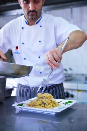 Chef decorating pasta salad