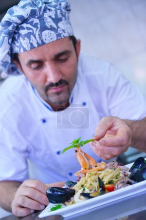 Chef decorating pasta salad