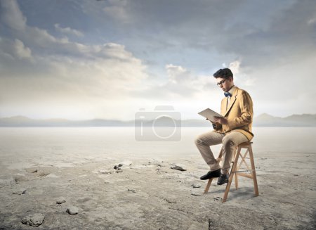 Businessman working isolated in the desert