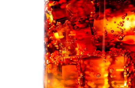 Cola with ice and bubbles in glass